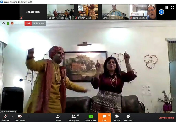 Groom Sushen Dang (L, dancing with a family member) took his vows online from his home in Mumbai while bride Keerti Narang joined the virtual nuptials from Bareilly in northern Uttar Pradesh state