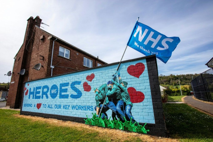 Street art graffiti paying tribute to the National Health Service mimics the epic flag raising by US marines on the Japanese island of Iwo Jima in World War II.