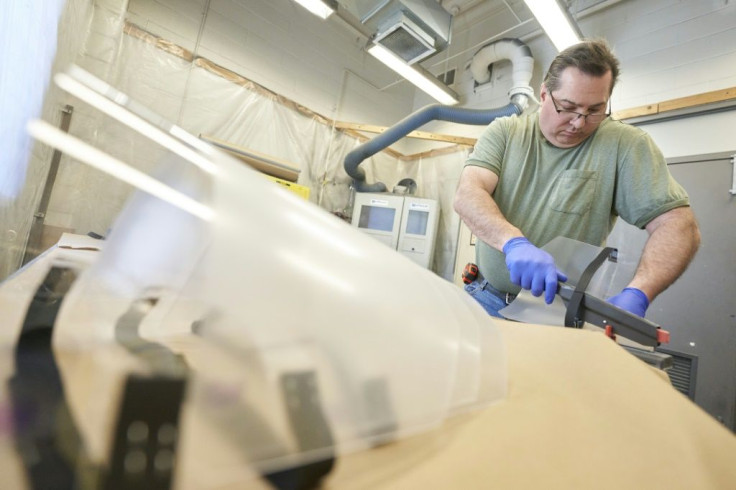 Canada shed 3 million jobs in March and April. Some sectors, however, retooled to make masks and other medical equipment for the pandemic fight. Pictured, machinist Steve Arnold works on assembling face shields for health care workers at Western Universit