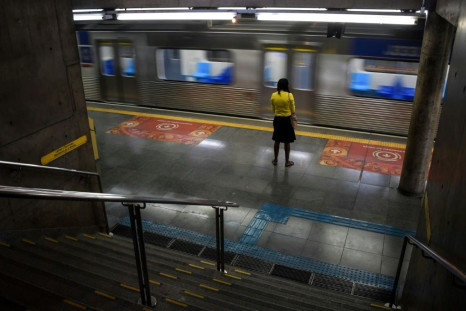 A woman stands at the Sumare subway station during the  COVID-19 pandemic in Sao Paulo, Brazil