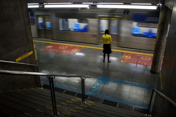 A woman stands at the Sumare subway station during the  COVID-19 pandemic in Sao Paulo, Brazil