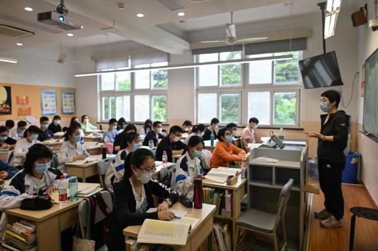 Students wear face masks in a classroom as school reopens in Shanghai