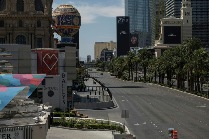 A car drives down the Las Vegas strip, which the pandemic has deprived of its drunken revelers and packed poker tables
