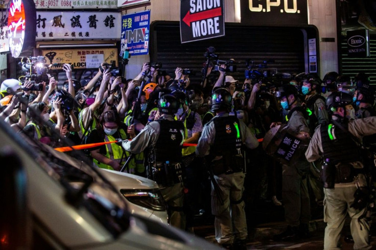 Hong Kong riot police hold back reporters during an operation to arrest pro-democracy demonstrators