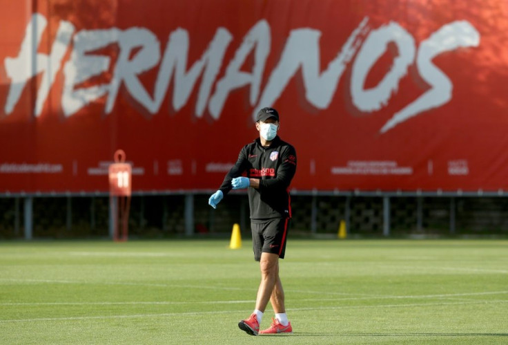 Waiting for the gloves to come off: Atletico Madrid coach Diego Simeone runs a training session