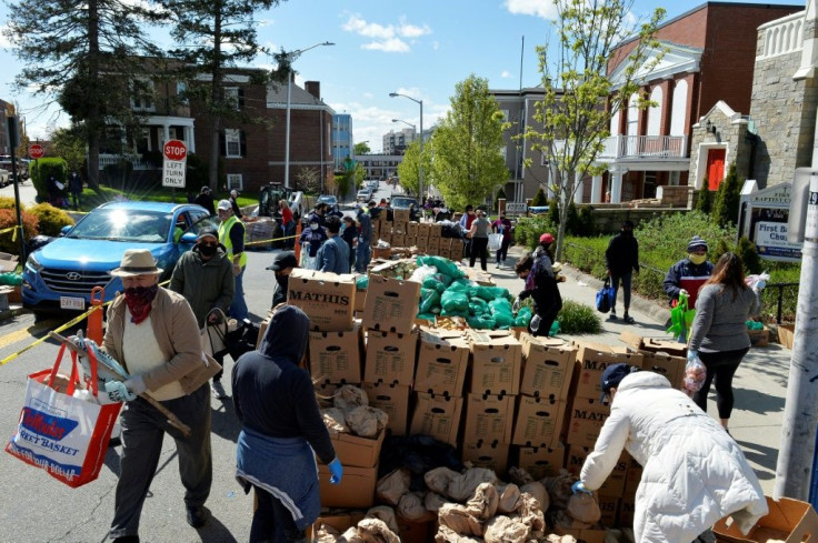 Volunteers distribute food to people in need during the weekly food pantry service run by Grace Ministries of the North Shore in Everett, Massachusetts