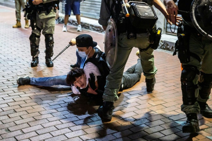 A Hong Kong pro-democracy demonstrator is held on the ground before getting arrested by police during a protest