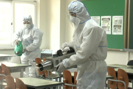 Health officials disinfect a high school in Seoul as schools are set to re-open, firstly to high school seniors, following the government's decision to relax coronavirus restrictions.