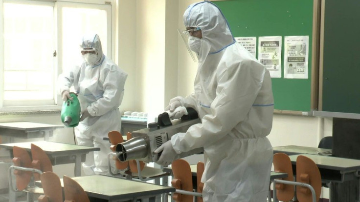 Health officials disinfect a high school in Seoul as schools are set to re-open, firstly to high school seniors, following the government's decision to relax coronavirus restrictions.