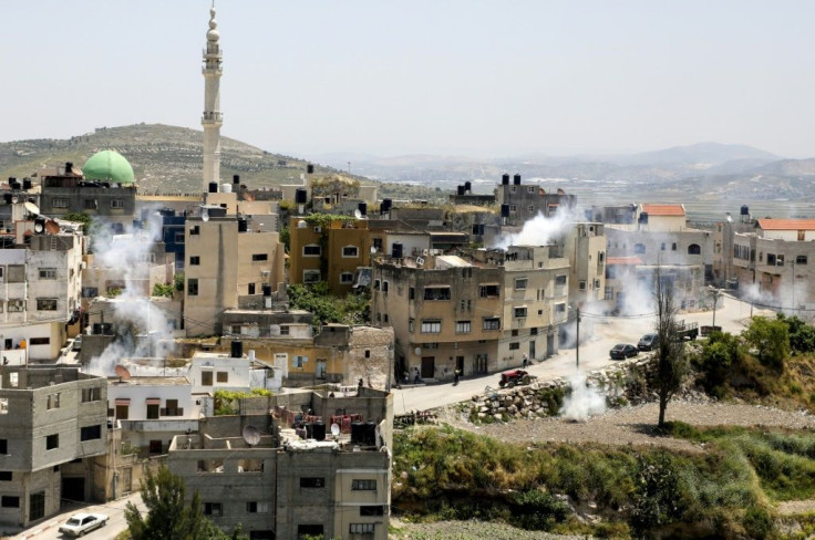 Smoke from teargas canisters billows in the village of Yabad near the West Bank city of Jenin during a search operation by Israeli forces after the death of an Israeli soldier