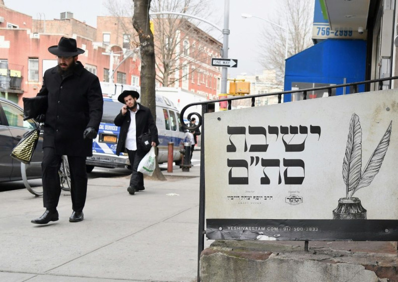 (FILES) In this file photo Orthodox Jewish men walk in the Brooklyn neighborhood of Crown Heights on February 27, 2019 in New York. The United States saw a record number of anti-Semitic incidents last year, including a sharp spike in physical attacks, the