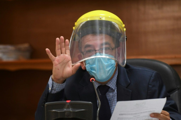 Judge Miguel Angel Galvez wears a face shield and a mask during a hearing against Guatemalan ex-president Otto Perez in Guatemala City on May 12, 2020