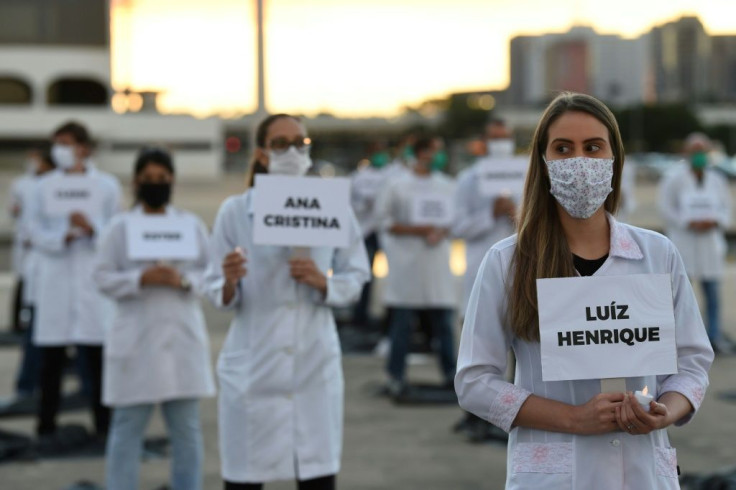 Brazilian nurses honor health workers who have died of COVID-19 during a demonstration in Brasilia