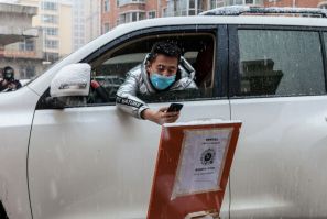 A driver scans a QR code to register information before entering a community in the border city of Suifenhe, in China's northeastern Heilongjiang province