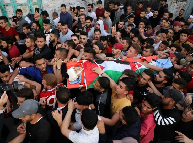 Palestinian mourners carry the body Zaid Qaysia, 15. Israeli forces shot dead the teenager during clashes in the occupied West Bank, the Palestinian health ministry said