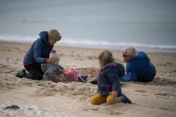 A family play on the beach in La Baule, after France eased lockdown measures taken to curb the spread of the COVID-19