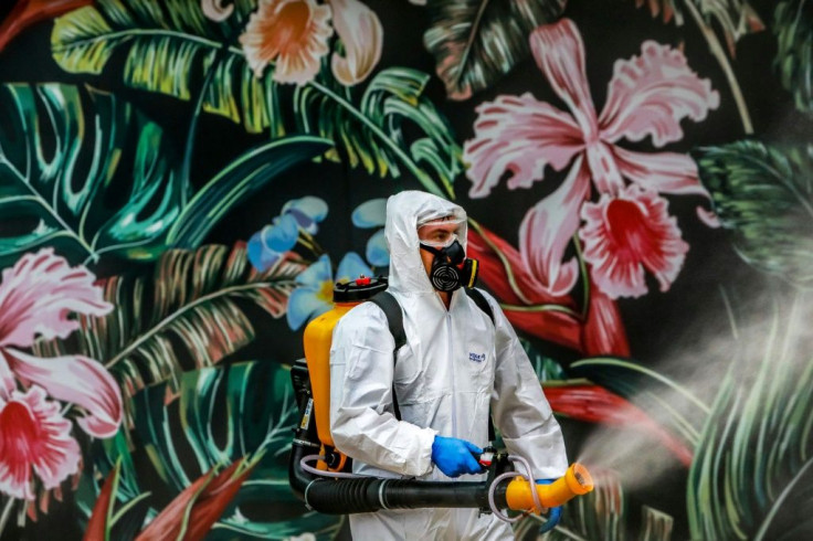 An employee wearing protective gear disinfects a shopping mall as a preventive measure against COVID-19  in Caxias do Sul, Brazil