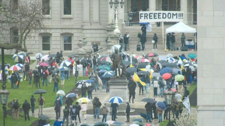 Demonstrators gather outside Michigan's State Capitol in Lansing to protest against coronavirus stay-at-home orders which are in place until May 28.