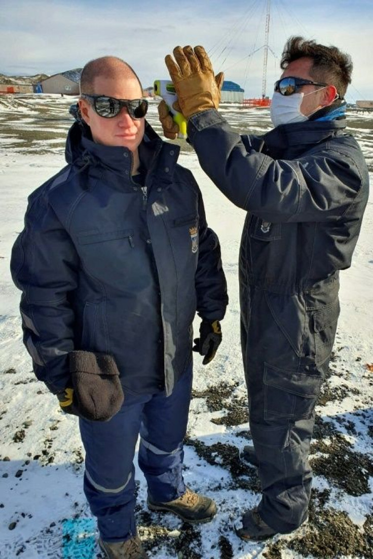 A Chilean Air Force doctor checking the temperature of personnel at the Eduardo Frei Antarctic base on the Fildes Peninsula, on May 10, 2020