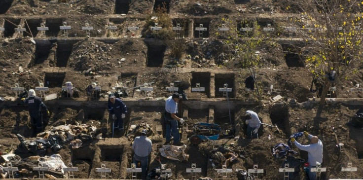 Workers dig graves in Santiago's General Cemetery after health authorities ordered them to prepare for a possible surge in deaths from COVID-19