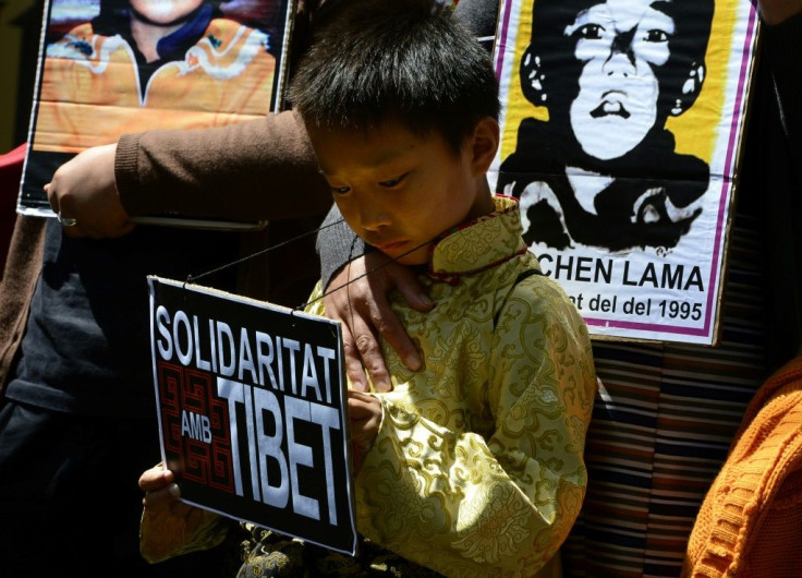 Protesters hold pictures of the missing Panchen Lama recognized by the Dalai Lama in a 2013 demonstration outside the Chinese consulate in Barcelona