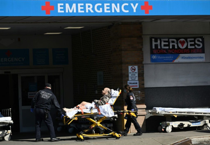 Medical workers transport a patient outside a special COVID-19 area at Maimonides Medical Center in New York City