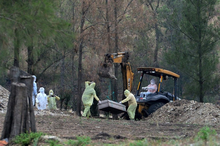 City workers bury COVID-19 victims at Jardin de los Angeles Cemetery, north of Tegucigalpa, Honduras