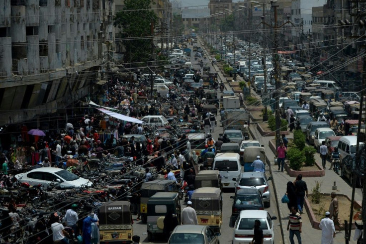 Commuters make their way along a busy street in Karachi in Pakistan after the government eased a nationwide lockdown