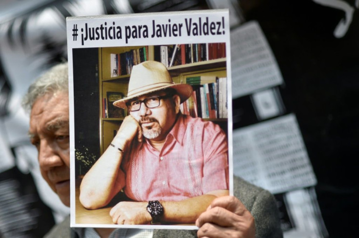 A demonstrator holds a picture of slain Mexican journalist Javier Valdez during a protest in Mexico City on May 16, 2017