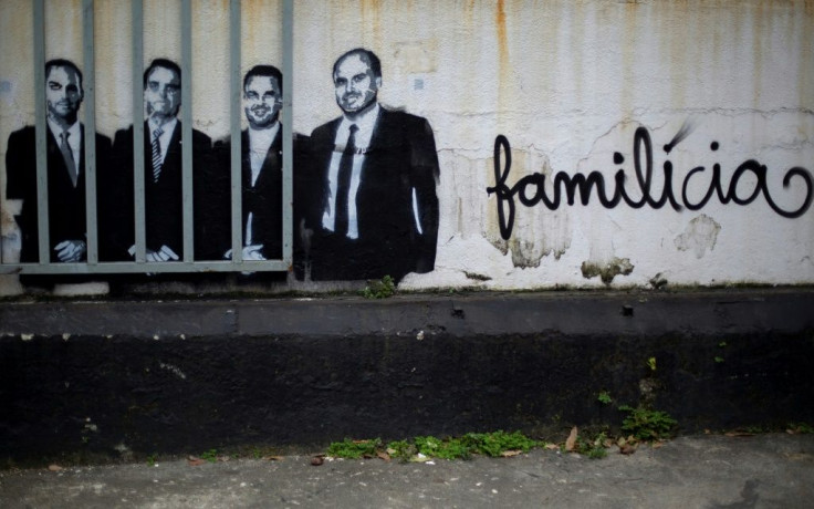 A mural in Rio de Janeiro depicts President Jair Bolsonaro (2-L) and his sons congressman Eduardo (L), senator Flavio (1-R) and councilman Carlos (2-R) with the slogan âFamilitiaâ -- a combination of the words family and militia