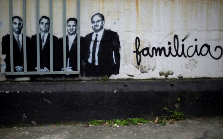A mural in Rio de Janeiro depicts President Jair Bolsonaro (2-L) and his sons congressman Eduardo (L), senator Flavio (1-R) and councilman Carlos (2-R) with the slogan âFamilitiaâ -- a combination of the words family and militia