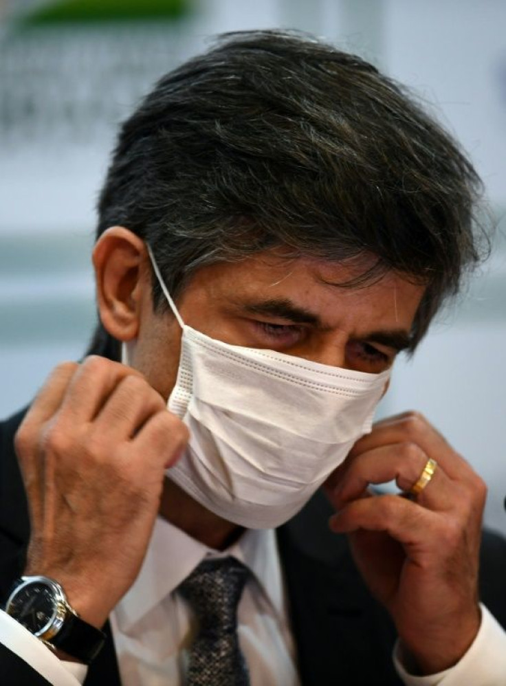 Outgoing Health Minister Nelson Teich puts on a face mask during a press conference in Brasilia, Brazil, on May 15, 2020