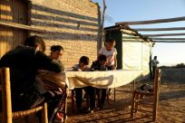 Nancy Jofre helps her four children with their homework near San Jose in the Lavalle desert area of Argentina's Mendoza province