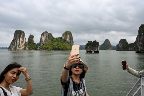 Local tourists take selfies in Ha Long Bay