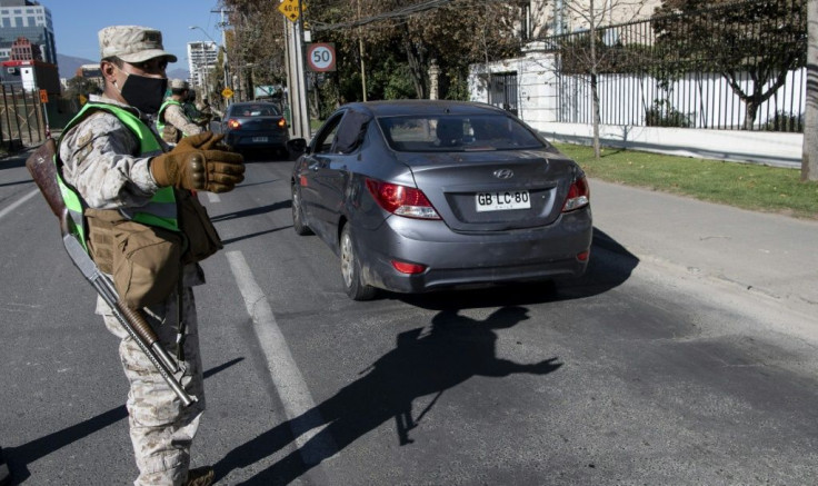 Soldiers stop cars at a checkpoint in Santiago, amid mandatory total quarantine due to the new coronavirus pandemic