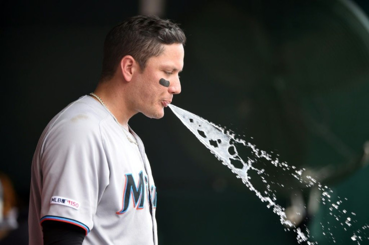 Miami Marlins Miguel Rojas spits out water in the dug out in the second inning during a baseball game in 2019 against the Washington Nationals.