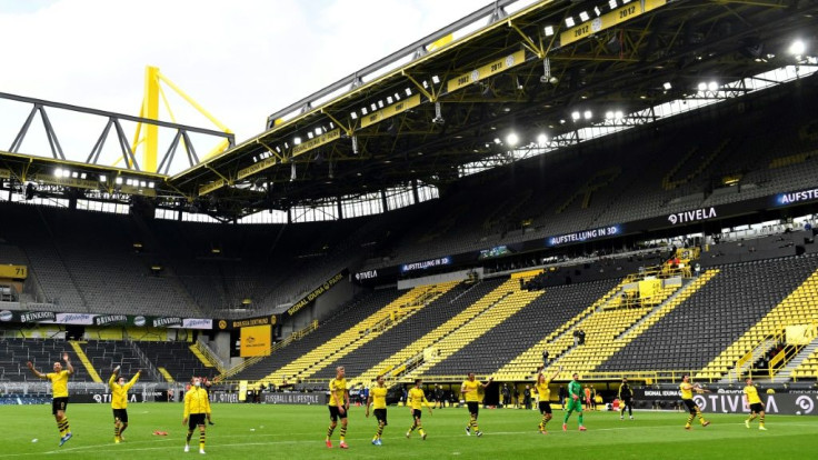 Dortmund's players celebrate in front of an empty "yellow wall" at Signal Iduna Park after thumping Schalke