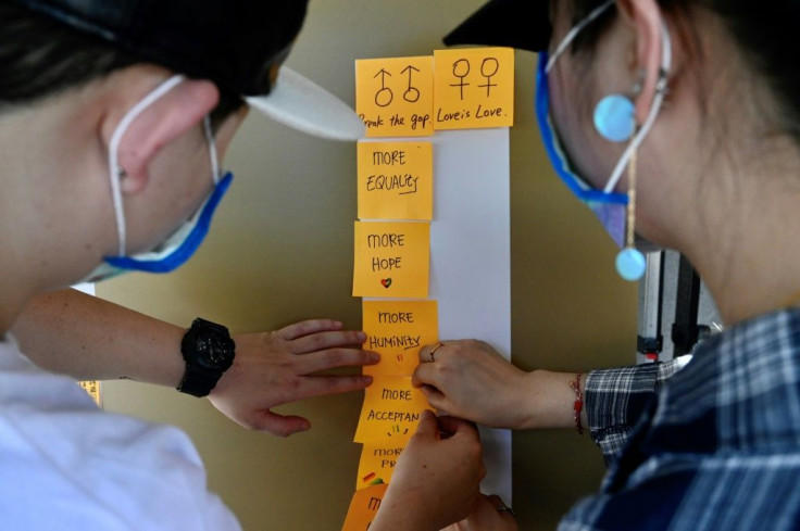 People paste notes on a 'Lennon Wall' in front of the Presidential Office in Taipei calling for a same-sex marriage law to be expanded to include more foreign nations