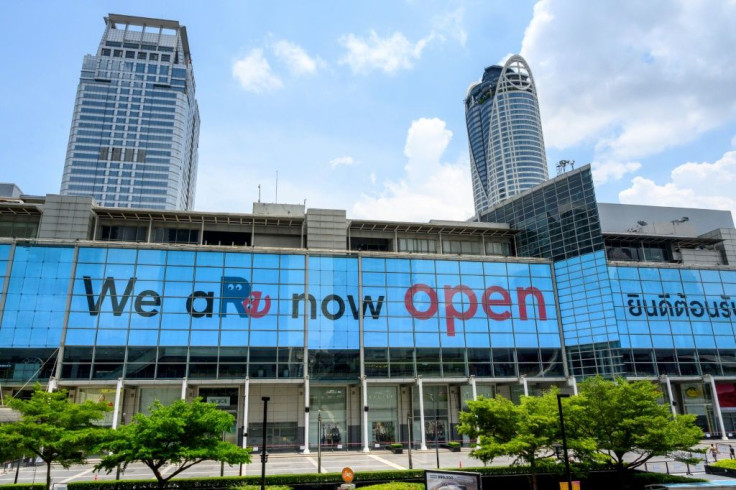 A giant screen welcomes visitors to the Central World shopping mall in Bangkok after virus restrictions were lifted