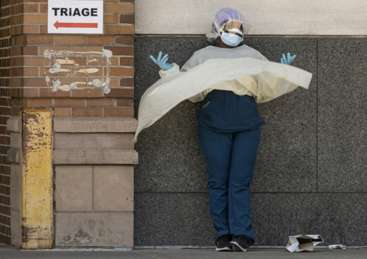 A medical worker takes a break outside a special COVID-19 area at Maimonides Medical Center in New York City