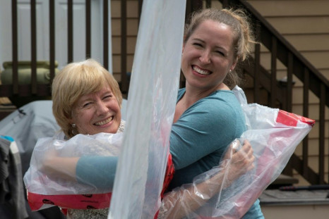 Carolyn Ellis (R) hugs her mother Susan Watts using the "hug glove" that Carolyn and her husband Andrew created as a Mother's Day gift in Guelph, Ontario, Canada