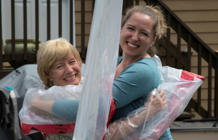 Carolyn Ellis (R) hugs her mother Susan Watts using the "hug glove" that Carolyn and her husband Andrew created as a Mother's Day gift in Guelph, Ontario, Canada
