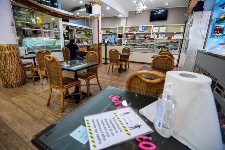 Hand sanitizer available for clients and tables set apart are part of the rules for reopening in Milan