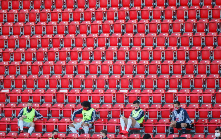 Bayern Munich substitutes wearing protective face masks maintain social distance during Sunday's 2-0 win at Union Berlin.