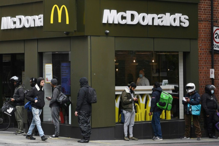 Delivery riders queue up outside a McDonald's in London in May 2020; the company is facing a sexual harassment lawsuit filed at the OECD by an international coalition of labor unions