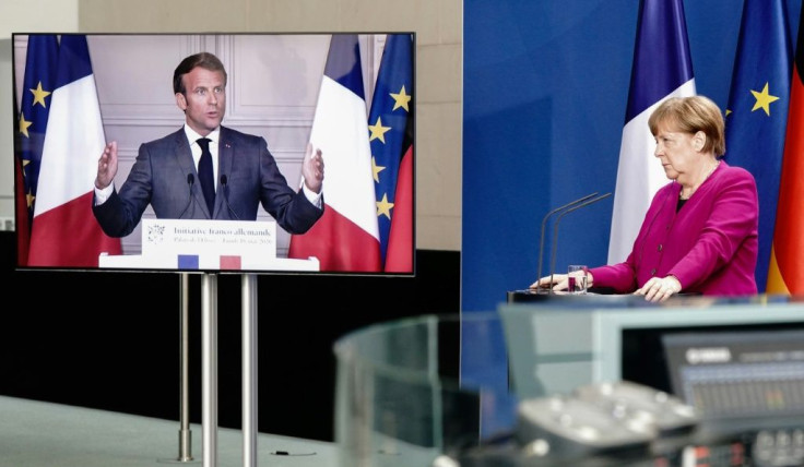 German Chancellor Angela Merkel (right) listens during a joint press conference with French President Emmanuel Macron on their 500 billion euros EU recovery programme