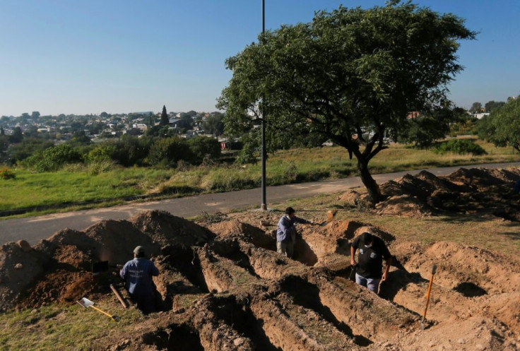 Grave diggers prepare plots at the San Vicente cemetery in Cordoba following a spike in coronavirus cases
