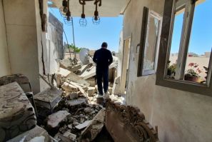 A resident walks through a building damaged by fighting in the Libyan capital Tripoli, on May 1, 2020