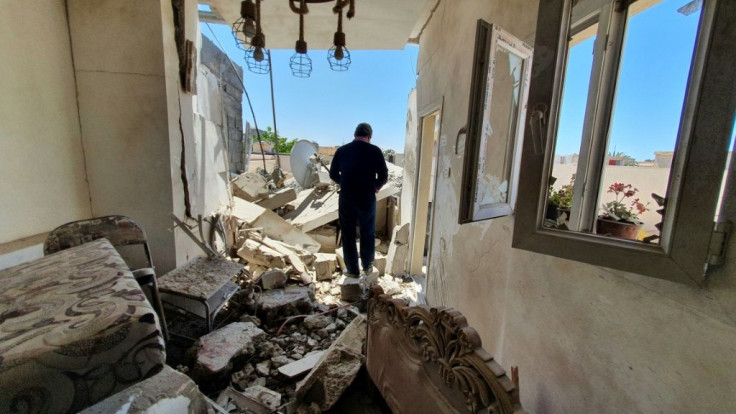 A resident walks through a building damaged by fighting in the Libyan capital Tripoli, on May 1, 2020
