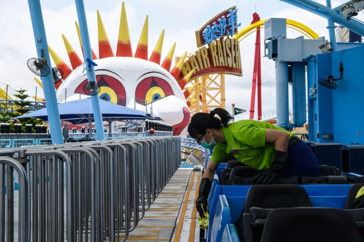 A worker disinfects the Arctic Blast roller coaster ride at the currently closed Ocean Park in Hong Kong, as the theme park seeks a huge financial bailout from the government
